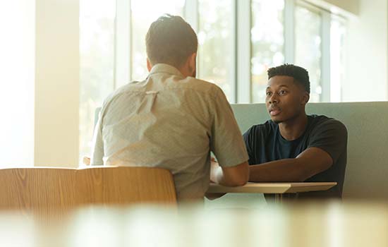 Two men talking and consulting